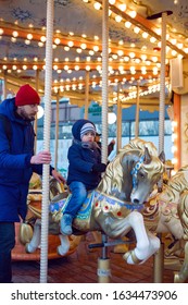 son and dad ride a carousel in winter in Moscow 2020 for Christmas