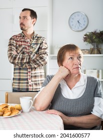 Son defends his position before adult mother at home