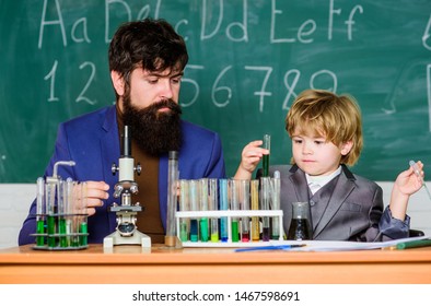 son and father at school. small boy with teacher man. training room with blackboard. Flask in scientist hand with Test tubes. Wisdom. Back to school. Imagine Greatness - Powered by Shutterstock