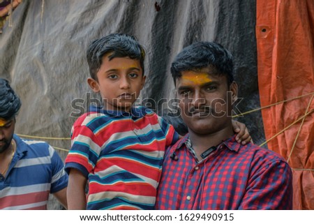 Son and father setting at temple steps in india