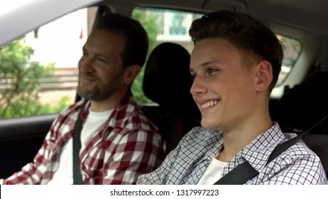 Son With Father Testing New Bought Car, Dad Teaching Teen Boy To Drive Auto