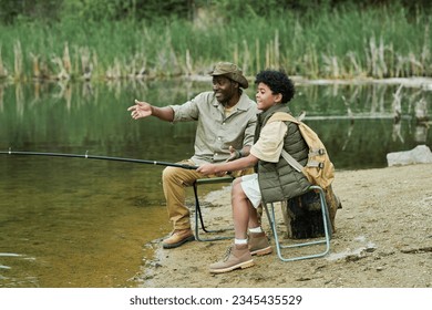 Son fishing together with his dad - Powered by Shutterstock