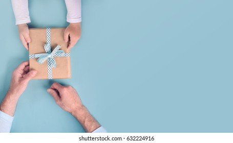 Son gives a gift to dad. Father's Day. - Shutterstock ID 632224916
