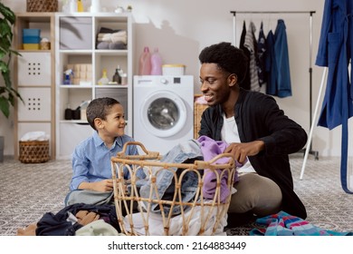 Son helps dad with household chores, man sort laundry, fold clothes, prepare for drying, spend time together in the bathroom teaching the girl how to use the washing machine.