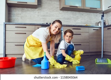 Son Helps Mom Clean Up In The Kitchen. 