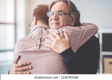 Son hugs his own father - Shutterstock ID 1130787608