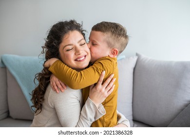Son is kissing his mother. Mom and son. Happy mother's day! Mother hugging her child. Shot of an adorable little boy affectionately kissing his mother at home
