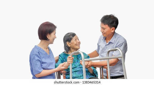 Son Looking After Elderly Mother On Wheelchair With Caregiver