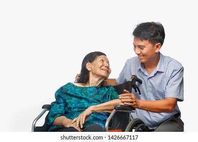 Son Looking After Elderly Mother On Wheelchair