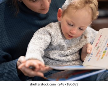 Son looking at book with mother?