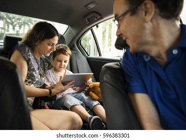 Son And Mom Using Tablet On The Car