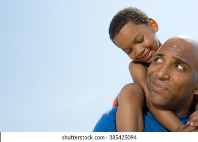Son on fathers shoulders - Shutterstock ID 385425094