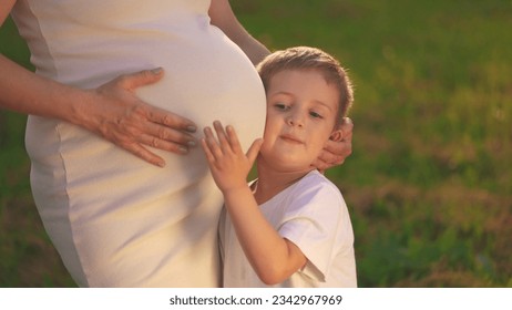 a son pregnant mother. little boy hugs his pregnant mom belly. son pregnant mom happy family kid dream concept.woman experiences motherhood for second time, boy will become the older brother lifestyle - Powered by Shutterstock