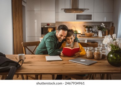 Son read a book and have fun while spend time with his father at home - Powered by Shutterstock