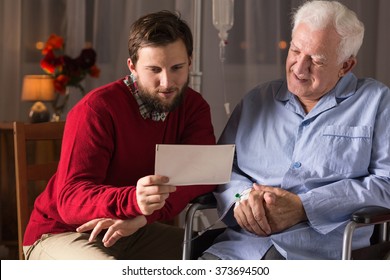 Son visiting ill father in rest home