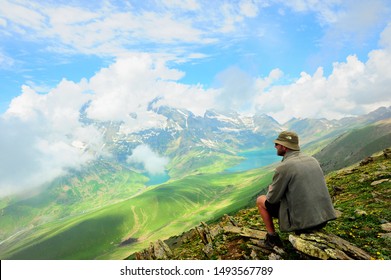 Sonamarg,India -  ‎July ‎22, ‎2019 : Man Traveler sitting on top of a mountain. Beautiful mountain view of Sonamarg, Jammu and Kashmir, India.