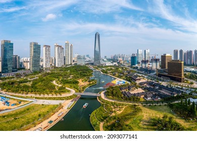Songdo, Yeonsu-gu, Incheon, South Korea - June February July , 2021: High angle and summer view of pleasure boats on canal of Central Park against Northeast Trade Tower in the background

