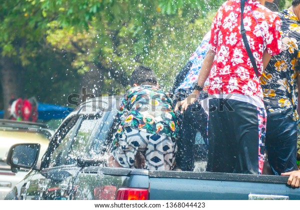 Songkarn Festival. The picture was taken on April\
13, 2019 at Chiang mai city, Thailand. The picture is about the\
people play water with fun and happiness on the street around\
Chiang mai city.