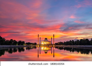 Songkhla Central Mosque in day to night with colorful skies at sunset and the lights of the mosque and reflections in the water in landmark landscape concept