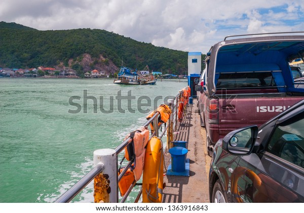 Songkhla, Thailand - Oct 2015:\
Ferry crossing Songkhla canal and overloaded boats in the\
background.