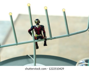 Songkhla, Thailand - october 9, 2017:  Ant man action figure from Marvel ant man comic and movie. ant man is sitting lonely on the lamp. small, white background
