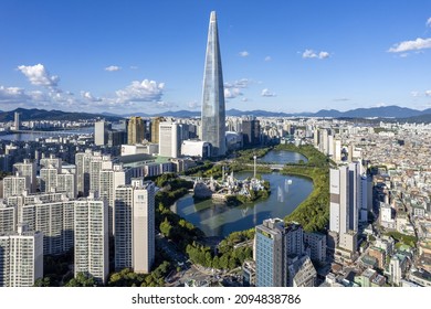 Songpa-gu, Seoul, South Korea - September 18, 2021: High angle and panoramic view townhouse and highrise apartments with Lotte World Tower besides Seokchon Lake in summer
