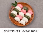 Songpyeon is a steamed rice cake made by kneading nonglutinous rice flour and stuffing it into a half-moon shape.