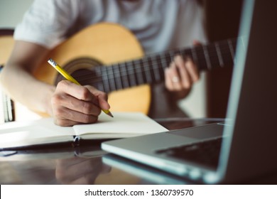 songwriter thinking and writing notes,lyrics in book at studio.man playing live acoustic guitar.concept for musician creative.artist composer in work process.people relaxing time with instrument - Shutterstock ID 1360739570