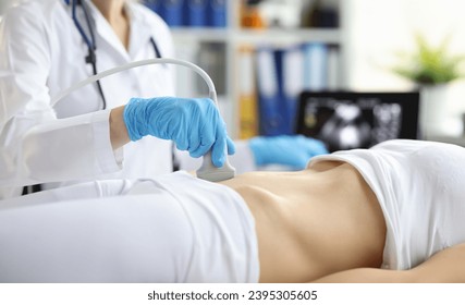 Sonographer technician holds ultrasound probe to diagnose condition of pregnant woman looking at woman uterus on computer screen. Ultrasound of uterus and female reproductive system concept - Shutterstock ID 2395305605