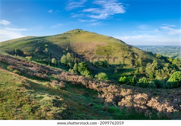 Soon\
after sunrise in the summer,looking southwards at the second main\
hill from the north of the Malvern hill range.Sugarloaf Hill lies\
between the Worcestershire Beacon and North\
Hill.