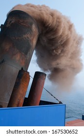 Soot And Smoke Billowing On The Stack Of A Ship.