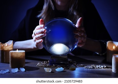 Soothsayer Using Crystal Ball To Predict Future At Table In Darkness, Closeup. Fortune Telling