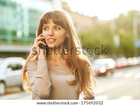 Sophisticated businesswoman in dress talking on the phone.