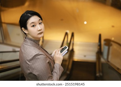 Sophisticated Businesswoman Using Smartphone in Upscale Environment - Powered by Shutterstock