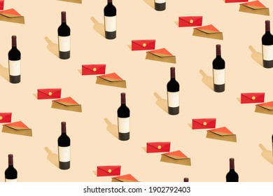A sophisticated fashionable pattern created with a bottle of red wine and three envelopes neatly arranged on a pastel beige background. Minimal concept.