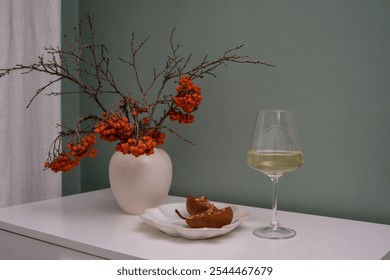 A sophisticated and refined setting that includes a wine glass, a delectable dessert of backed pears and autumn bouquet in ceramic vase. - Powered by Shutterstock