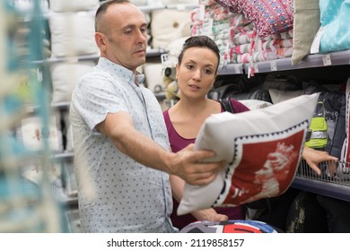 Sopping Couple Choosing Cloths At Home Decoration Store