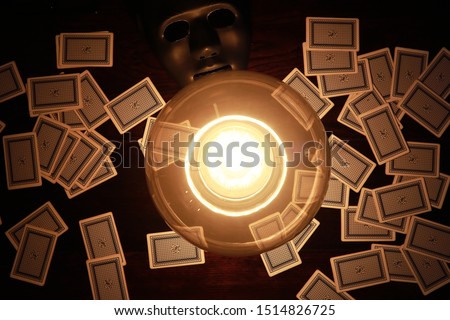 A sorcerer's table with a fortune-teller ball and mask
