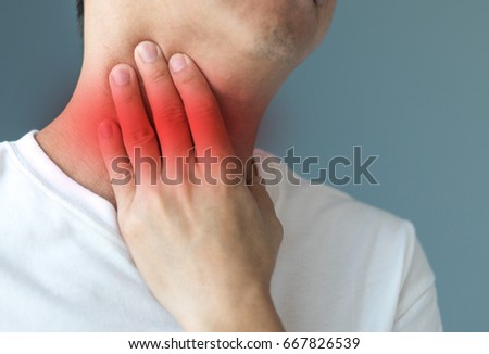 Sore throat healthcare concept. Hand of man touch his neck with red spot as sickness with  pharynx inflammation disease  Stock photo © 