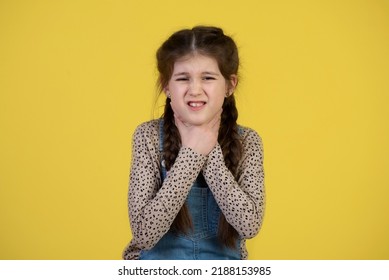 Sore Throat Remedies. Kid Feels Pain In Throat. Girl Cute Kid Suffer From Pain In Neck. Girl Painful Face Stand  Background. Health Care And Medicine. Sore Throat Remedies. Throat Pain Treatment