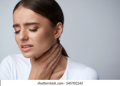 Sore Throat. Sick Woman Feeling Bad Suffering From Throat Pain, Painful Swallowing. Portrait Of Beautiful Ill Girl Caught Cold, Holding Hand On Neck. Illness, Health Concept. High Resolution
