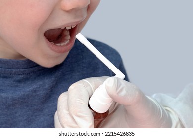 Sore Throat Treatment Concept.cute Baby Boy Preschooler Kid Using Honey Lemon Ingredients Spray For Red Neck Pain.doctor Medical Assistant Hand In Surgical White Glove.smiling Child Home Isolated Mock