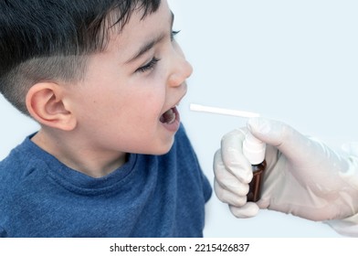 Sore Throat Treatment Concept.cute Baby Boy Preschooler Kid Using Honey Lemon Ingredients Spray For Red Neck Pain.doctor Medical Assistant Hand In Surgical White Glove.smiling Child Home Isolated Mock