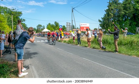 Sorgues, Vacluse, France, 7 July 2021 : Men Cycle On The Tour De France, French National Bicycle Stage Race, And Fans Watching, Cheering Racers And Photographing The Event Standing On The Roadside