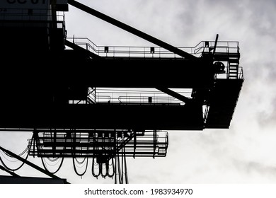 Sorong, West Papua, Indonesia, May 31st 2021. The silhouette of Quay Gantry Crane (QC). The counter weight beam of Ship to Shore Crane  (STS) at  yard of Sorong harbor.