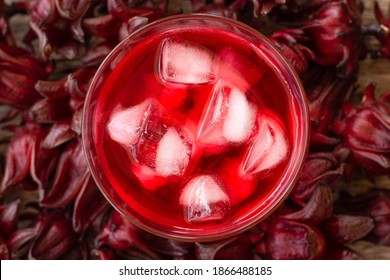 Sorrel juice or hibiscus tea with roselle flowers. Top view. Flat lay.