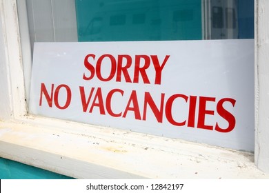 Sorry no vacancies sign in a guesthouse window.