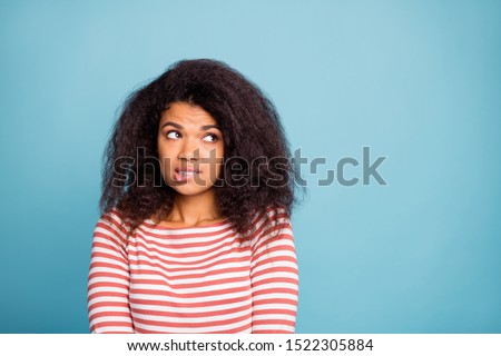 I'm so sorry! Photo of pretty dark skin lady looking empty space with guilty eyes biting lips apologizing wear casual clothes isolated pastel blue color background