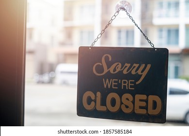 Sorry we are closed sign. coffee cafe shop text on vintage sign board hanging on glass door in modern cafe shop reopen after coronavirus or covid 19 quarantine is over in restaurant ready to service.