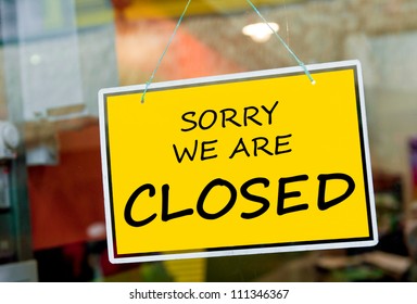 sorry we are closed sign hanging on a window door outside a restaurant, store, office or other
